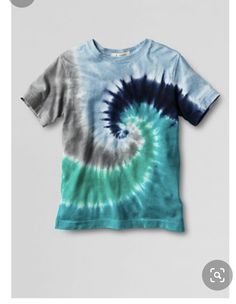 a blue and green tie - dyed t - shirt hanging on a white hanger