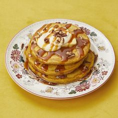 a stack of pancakes covered in caramel drizzle