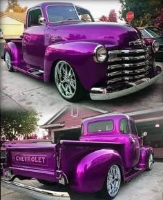 an old purple truck parked in front of a house next to another classic pink truck