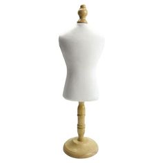 a white mannequin on a wooden base