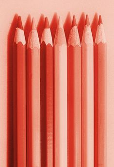 six pink pencils lined up in a row