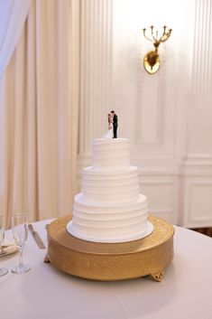 a white wedding cake sitting on top of a table