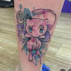 an elephant tattoo on the leg with watercolor paint splatters and stars around it