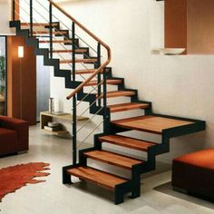 a living room filled with furniture and a stair case