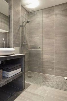 a bathroom with a sink, mirror and shower stall