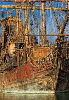 an old wooden pirate ship in the water