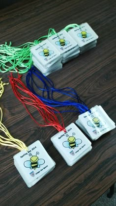 four game pieces sitting on top of a table with wires attached to them and some cords in the middle