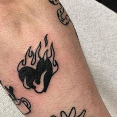 a man's foot with tattoos on it and flames coming out of the top