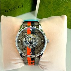 Brand New In Box. 100% Authentic Gucci G-Timeless Tiger Watch Style Ya1264186 This G-Timeless Watch Is Characterised By The Printed Motto 'Gucci Tiger.' References To The Feline Are Often Seen Throughout The Creative Director's Collections As An Expression Of The House's Fascination With The Wild Beauty Of The Natural World. Presented With A Steel Case And Gg Supreme Strap And Dial, The Style Is Completed By Orange And Black Stripes And Light Blue Holders Size 38mm Comes In Exactly As Shown. Inc Gucci Luxury Automatic Watch, Gucci Luxury Watch Accessories With Round Dial, Gucci Luxury Watch With Round Dial, Gucci Automatic Round Watches, Gucci Luxury Automatic Watch Accessories, Luxury Gucci Watch Accessories With Diamond Hour Markers, Luxury Gucci Quartz Watches, Black Gucci Watch With Subdials, Luxury Gucci Watch With Diamond Hour Markers