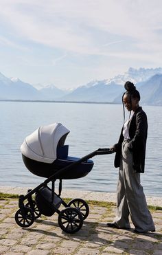 a woman standing next to a baby carriage