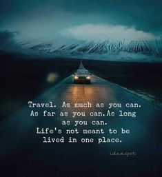 a car driving down the road at night with an inspirational quote about travel as much as you can