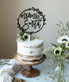 a cake sitting on top of a table next to flowers