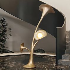 a lamp that is sitting on top of a table next to some steps and stairs