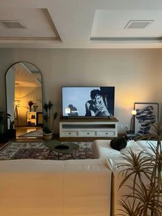 a living room filled with furniture and a flat screen tv