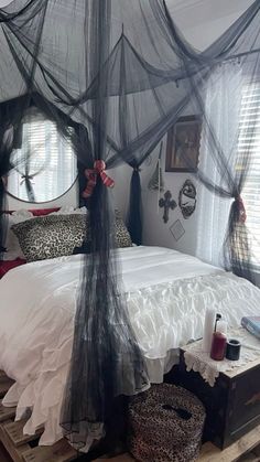 a bed with mosquito netting over it in a bedroom