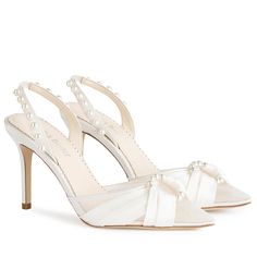 a pair of women's shoes with pearls on the toes and heels in white satin