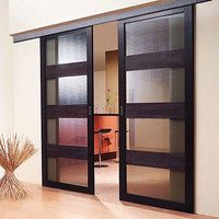 an open sliding glass door in a room with wood flooring and white walls on the other side