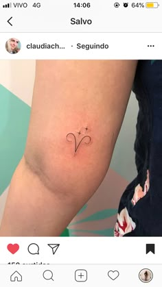 a small tattoo on the leg of a woman's left arm, with an arrow in