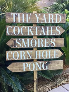 a wooden sign that says the yard cocktails smores corn hole pong on it