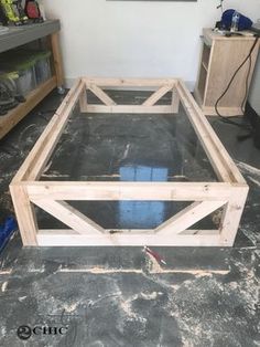 a wooden bed frame sitting on top of a floor