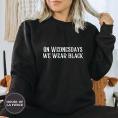 "\"On Wednesdays We Wear Black\" Adult Sweatshirt This soft sweatshirt has a loose fit for a comfortable feel. :: SIZING :: - This trim-blend sweatshirt fits true to size, if you are in between sizes, we recommend sizing up - Please check out our size chart for measurements to ensure an accurate fit - No exchanges/returns for wrong size orders :: WASHING INSTRUCTIONS :: - Turn garment inside out and wash cold. - Tumble dry on low temperature setting. - Do not iron directly on the print. ::GARMEN Black Punk Sweatshirt With Letter Print, Black Cotton Punk Style Sweatshirt, Edgy Black Halloween Sweatshirt, Black Punk Style Sweatshirt For Halloween, Black Punk Style Halloween Sweatshirt, Black Punk Sweatshirt For Halloween, Black Halloween Punk Sweatshirt, Black Band Merch Sweatshirt For Fall, Edgy Black Cotton Sweatshirt