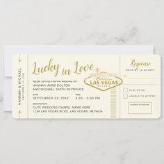 the las vegas wedding ticket is shown on a marble surface with white and gold lettering