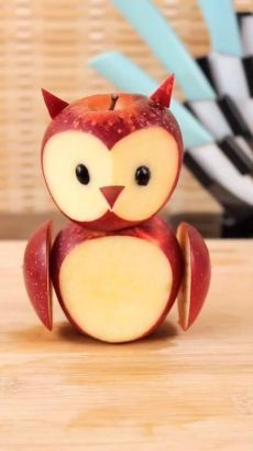 an apple shaped like an owl sitting on top of a table