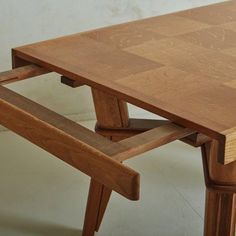 A 1940s French wood dining table featuring a sculptural trestle base with angular legs and scalloped stretcher detailing. This piece has a gorgeous parquetry top with a painterly natural wood grain. One side of the table extends to allow for an additional leaf. Does not retain the original leaf. Unmarked. Sourced in France, 1940s. Convertable Furniture, Dinning Tables, Trestle Dining Table, Trestle Dining Tables, Table Legs