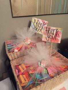 a basket filled with lots of candy and thank you notes on top of each other