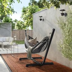 a hammock chair sitting on top of a wooden floor next to a wall