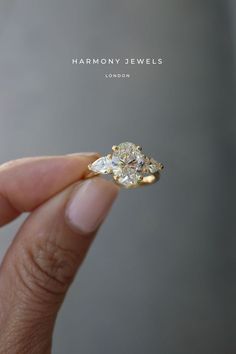 someone is holding an engagement ring in their hand with the words harmony jewels on it