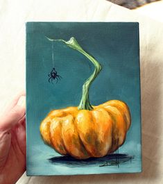 a painting of a pumpkin with a spider on it