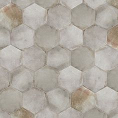 a tile floor with hexagonal tiles in grey and brown colors on the side