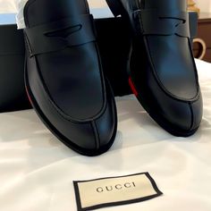 Black Gucci Loafers With Gucci Strips On The Side Of The Shoe. Very Elegant And Subtle Display Of Style. Never Worn, In Box With Original Papers. Designer Brogue Loafers For Office, Designer Leather Shoes With Brogue Detailing For Work, Black Tassel Loafers For Office With Branded Insole, Designer Business Tassel Loafers With Brogue Detailing, Designer Tassel Loafers With Rubber Sole For Business, Designer Brogue Loafers For Business Casual, Designer Black Leather Shoes For Work, Luxury Dress Shoes With Red Sole For Work, Gucci Luxury Slip-on Loafers