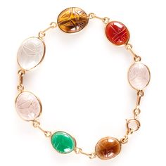 14k Yellow Gold Oval Cabochon Scarab Style Multi-Stone Bracelet 11.05gMetal Information: 14k Yellow GoldTotal Weight: 11.05gBracelet Width: 13mm - 3.5mmBracelet Length: 7.5"Stone InformationMain StoneGem Type: QuartzShape: Oval Cabochon (15.7mm x 11.75mm)Color: ClearClarity/Quality: ANumber of Stones: 1Accent StonesGem Type: QuartzShape: Oval Cabochon (13.2mm x 11.2mm / 11.8mm x 9.9mm)Color: Pink ClearClarity/Quality: ANumber of Stones: 2Accent StonesGem Type: AgateShape: Oval Cabochon (11.5mm x 9.4mm)Color: RedClarity/Quality: ANumber of Stones: 1Accent StonesGem Type: AgateShape: Oval Cabochon (11.5mm x 9.8mm)Color: Orange RedClarity/Quality: ANumber of Stones: 1Accent StonesGem Type: Tigers EyeShape: Oval Cabochon (13.7mm x 11.4mm)Color: BrownClarity/Quality: ANumber of Stones: 1Accent Yellow Gold Multi-stone Oval Bracelets, Yellow Gold Multi-stone Oval Bracelet, Yellow Gold Oval Bracelet With Multi-stone, Yellow Gold Oval Multi-stone Bracelet, Luxury Oval Bracelet With Natural Stones, Luxury Oval Bracelets With Natural Stones, Oval Cabochon Bracelets For Formal Occasions, Multi Stone, Oval Cabochon