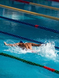 a man swimming in a pool with no shirt on