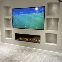 a flat screen tv mounted to the side of a wall above a fireplace in a living room