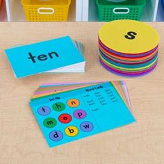 a table topped with lots of different types of cards and bins filled with books