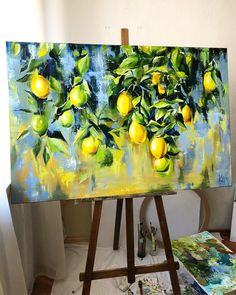 an easel is holding up a painting with lemons on it