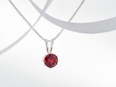 January Red, Mozambique Garnet Necklace. Round, 5mm, Gemstone in a 6-Prong, Sterling Silver Pendant. Great value! Chain Options. #SterlingSilver #mozambique #SilverPendantChain #RoundFaceted #BirthstoneNecklace #GarnetNecklace #RedGarnet #NaturalGarnet #JanuaryPendant #RedPendant Red Round Necklace For Her, Round Garnet Gemstone Necklaces, Classic Ruby Necklace As A Gift, Garnet Birthstone Round Necklace, Elegant Red Birthstone Necklace For Gift, Elegant Red Birthstone Necklace Gift, Fine Jewelry Garnet Necklace As Gift, Garnet Round Necklace In Fine Jewelry Style, Red Round Pendant Birthstone Necklace For Formal Occasions