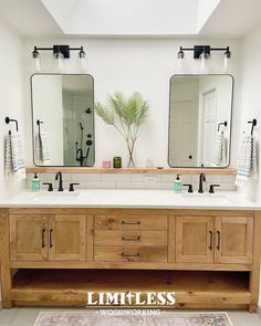 a bathroom with double sinks and two mirrors