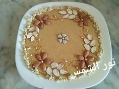 a cake decorated with flowers and pearls on a plate