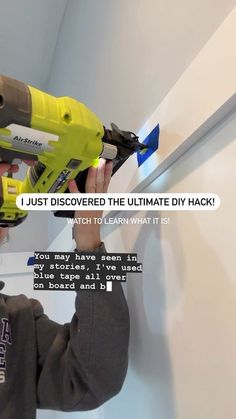 a man using a power drill to fix a hole in a wall with text on it