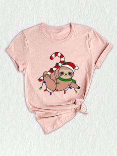 a pink t - shirt with a slotty on it's chest and candy canes around its neck