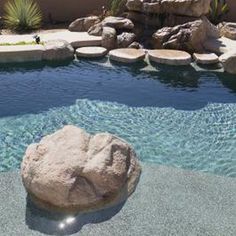 a rock in the middle of a pool