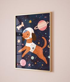 a dog in space is hanging on the wall