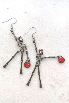 Elegant red bag lady skeleton earrings. Creepy but sweet, scarry but cute, frightening but happy... These earrings make you smile and add C-class horror movie look to your outfit. Check it and test how addictive skeletons earrings might be #skullmakeup #skullart #skullhead #skulljewelry #skullearrings #skulladdict #skulladdiction #earringsforsale #etsyearrings #halloweencostume #halloweenjewelry #halloweenearrings Spooky Red Halloween Jewelry, Red Novelty Jewelry For Halloween, Red Metal Halloween Earrings, Red Halloween Earrings, Red Earrings As Halloween Gift, Red Earrings For Halloween Gift, Fun Red Jewelry For Halloween, Red Fun Halloween Jewelry, Fun Red Halloween Jewelry