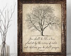 a tree with a bible verse on it and some branches in front of the frame