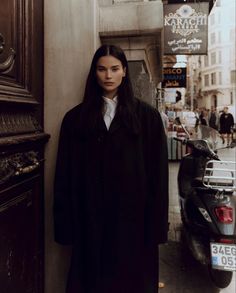 a woman standing in front of a building