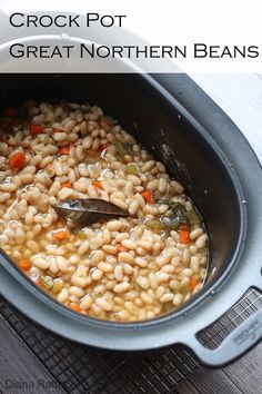 a spoon in a pot filled with beans and vegetables